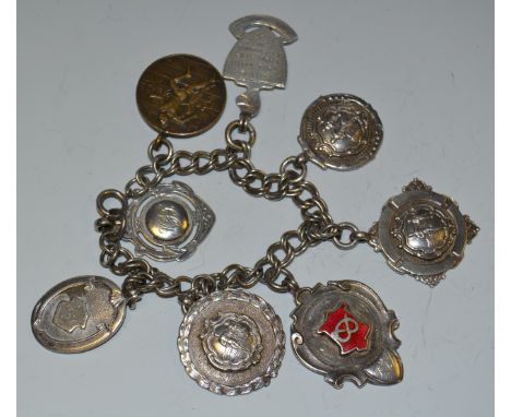 A silver and enamel athletics medal fob; others, on a silver chain as a bracelet