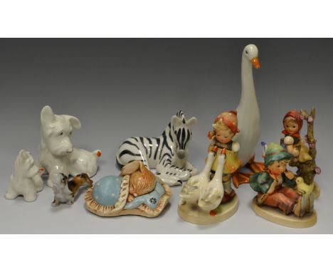 A Goebel figure, designed by MJ Hummel, Apple Tree Girl, printed marks;  others, Girl with two Geese;  Boy with flute and bir