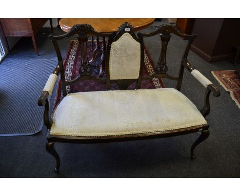 A Victorian mahogany two seater salon sofa, c.1860; a circular foot stool