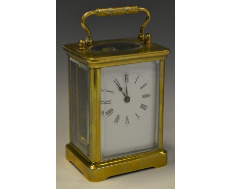 A brass carriage clock, Roman numerals, white enamel dial