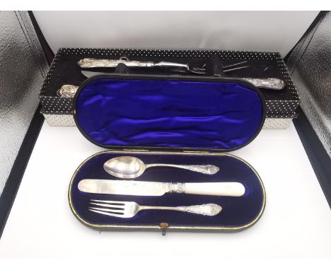 A boxed silver handled kings pattern carving set along with a leather cased Victorian engraved knife, fork and spoon set. The