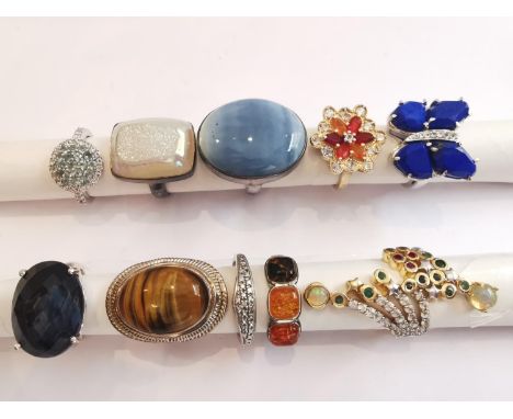 A collection of ten silver and gold plated silver dress rings set with various gemstones, including lapis lazuli, amber, chal