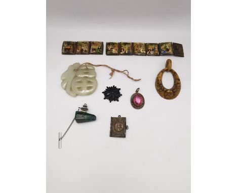 A collection of jewellery, including a miniature book charm with Napoleon on the front, a carved white jade Chinese character
