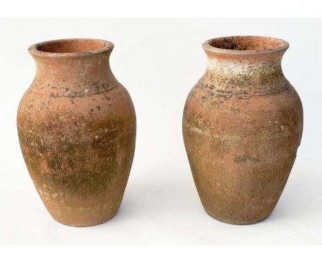 TERRACOTTA URNS, a pair, vintage weathered terracotta of vase form, 53cm H. (2) 