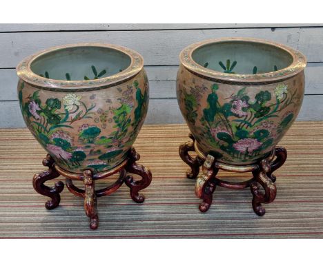 PLANTERS ON STANDS, a pair, Chinese style ceramic, wooden stands, 72cm H x 55cm diam approx. (2) 