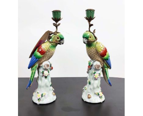 CANDLESTICKS, a pair, each in the form of a parrot on a perch, ceramic and gilt metal, 36cm H. (2) 