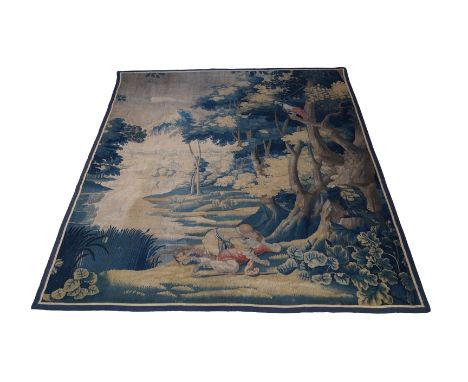 A verdure tapestry, 18th century, depicting two lovers in a woodland scene with a parrot perched on a tree and sheep grazing 