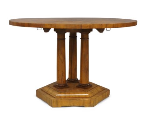 A Biedermeier walnut circular tilt top breakfast table, 19th century, the circular top raised on three cylindrical columns su