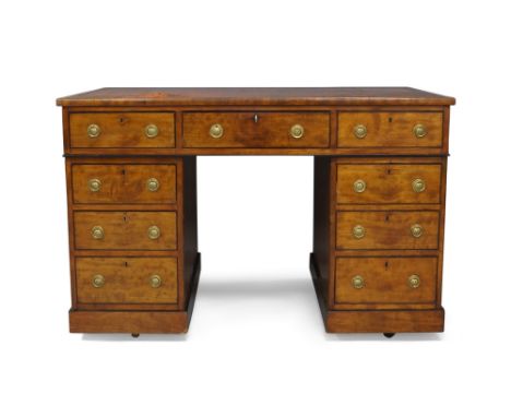 A Regency mahogany pedestal desk, ebony strung, with red leather skiver above an arrangement of nine drawers to front and thr