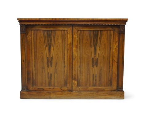 A William IV rosewood side cabinet, beaded frieze above two cupboard doors, enclosing shelf space, flanked by columns with ca