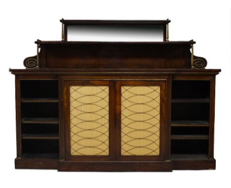 A Regency rosewood breakfront credenza, the mirrored back superstructure with brass gallery top and brass supports, above two