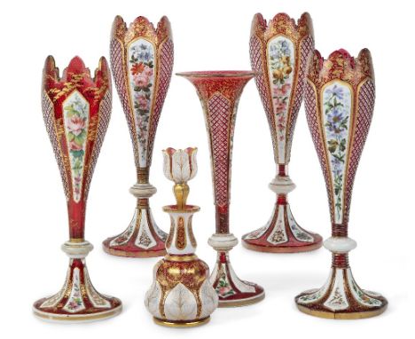 A group of Bohemian red glass vessels, 19th century, comprising: three vases of tulip form, flashed in white on ruby and pain