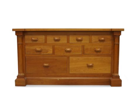 A cherry wood inverted breakfront chest, 21st century, with nine drawers flanked by cylindrical columns, raised on plinth bas