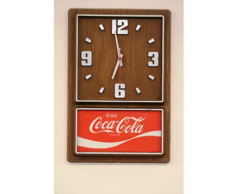 A 1970's Coca Cola advertising wall clock, 45cm x 30cm