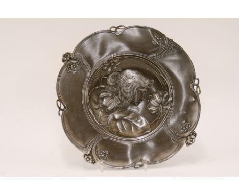 An Art Nouveau pewter plate,  decorated with female profile and floral surround, AF, marked verso 231, 31cm dia.