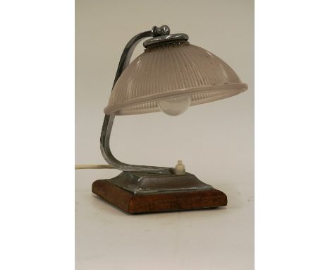 An Art Deco chromed desk lamp, raised on wooden base with glass shade, 24cm
