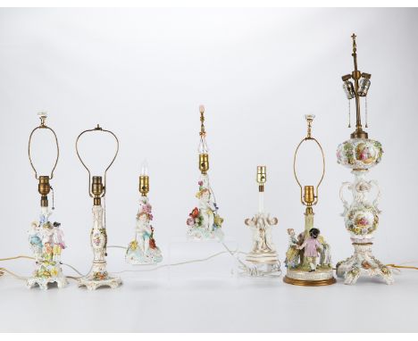 Group of seven German porcelain lamps featuring figural groups and hand painted floral bouquets. Six of the lamps marked Carl