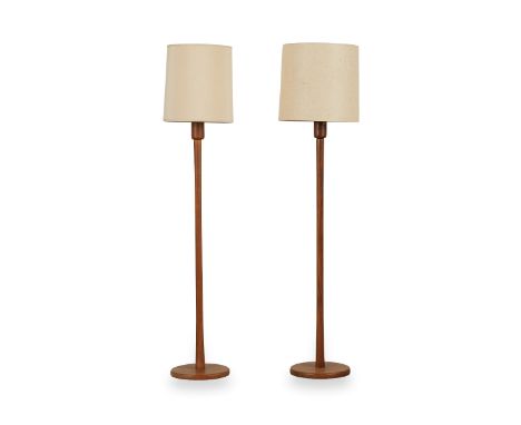 Pair of mid-century modern teak floor lamps with cloth shades differing in style.Each, height: 61 in x width: 15 in.Condition
