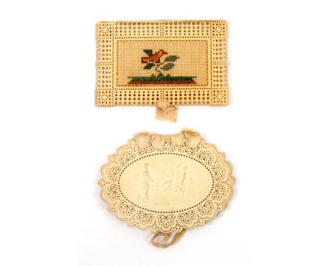 Two card needle books, comprising a fine oval example with pierced border pattern enclosing a pressed paper panel to one side