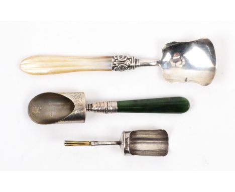 Three silver caddy spoons, comprising a shovel bowl floral engraved example with green agate handle, the bowl stamped 'Sterli