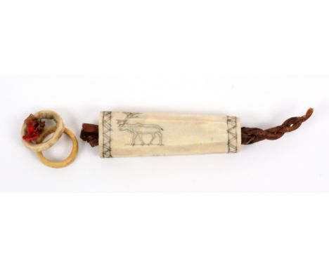 A rare 19th Century Eskimo reindeer bone and skin 'tubular' needle case, one side engraved with a reindeer, the other a geome