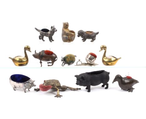 Twelve metal figural pin cushions, early 20th Century and later comprising a large brass frog, one glass eye only, 14cms, a w