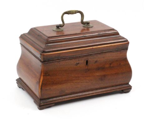 A mahogany tea caddy, circa 1800, of bombe form, raised on reduced bracket feet, boxwood edges, the moulded stepped lid with 