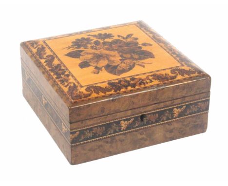A burr maple Tunbridge ware box of square form, the sides with a narrow band of mosaic, the hinged cushion lid with an inset 