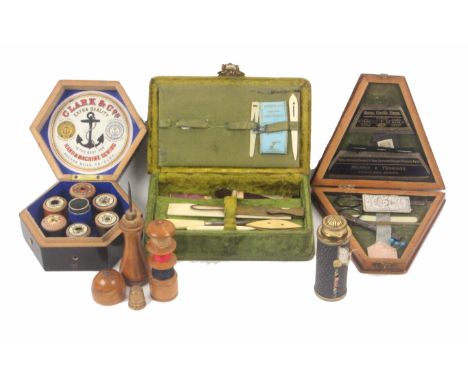 Four sewing companions and a reel box, comprising a green plush rectangular example with a few tools including a brass hem me