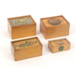 Four whitewood print and paint decorated rectangular boxes, all with sliding lids comprising an
