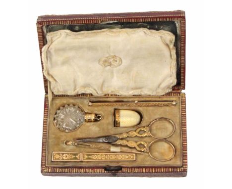 A Palais Royal gold sewing set circa 1820, in gilt tooled rectangular leather box, with mirror to lid interior, the flush fit