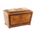 A golden figured oak Tunbridge ware tea caddy, of sarcophagol form, the front with a geometric