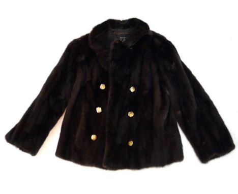 A circa 1970's chocolate brown mink jacket
Hip length, of fitted form with self lined double collar, and three pairs of featu