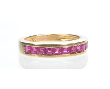 A ruby half hoop eternity ring
The channel set calibre-cut rubies, to an 18ct yellow gold shank, ring size K
