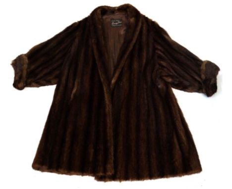 A Vintage ladies mink fur coat, circa 1970s
The 3/4 length A-line coat with narrow collar and flared turned cuff sleeves, wit