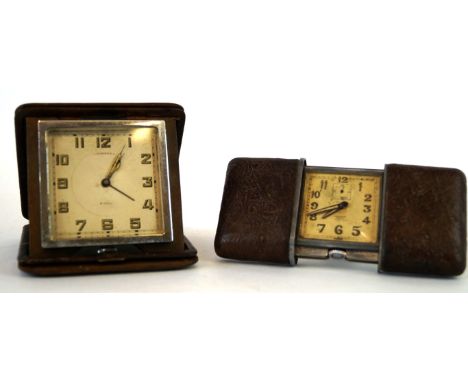 Two 1920s/30s travel alarm clocks 
The first a Movado 8-day example, with ostrich skin case and square dial with Arabic numbe