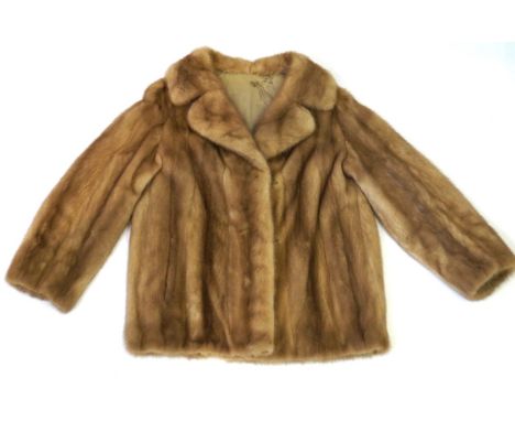 A Vintage ladies mink fur jacket, 20th Century
The light coloured jacket with wide double lapel and full length flared sleeve