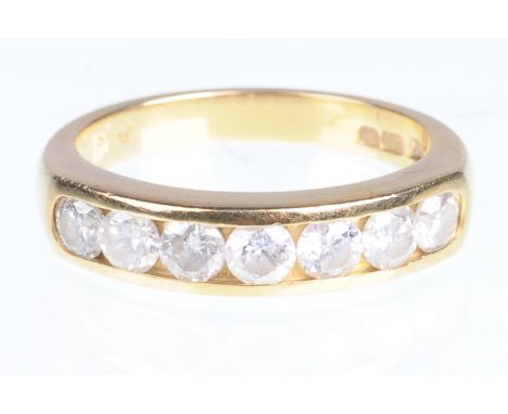 A diamond half hoop eternity ring
The seven round brilliant-cut diamonds, channel set, to an 18ct yellow setting, total diamo