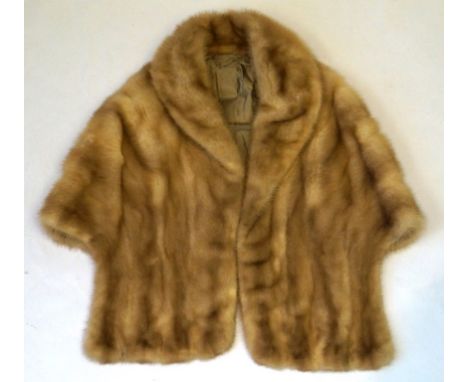 A circa 1960's light blond mink stole
With self lined collar to draping front panels, fully lined with floral detail fabric a