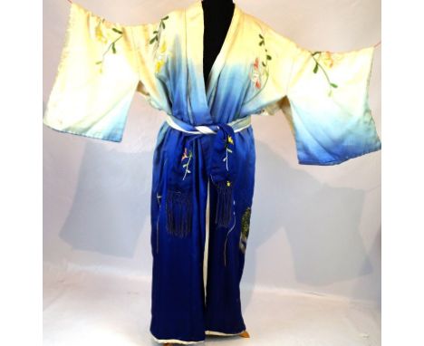 A Japanese silk embroidered kimono
Early to mid 20th century, the dyed graduated blue to white silk, embroidered to the front