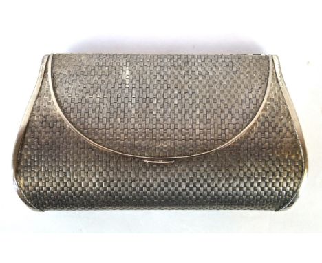 A white metal Harrods ladies clutch bag, Circa 1960 
Of tapered rounded form with basket weave engine turned type design, the