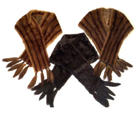 A collection of three mid 20th Century ladies mink fur stoles
To include a dark brown and two light brown examples of typical