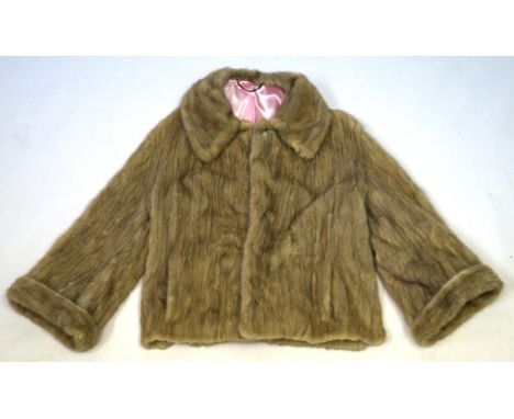 A ladies Vintage mink short jacket, circa 1960s/70s
The light cream coloured jacket with vertical pelts, adorned with a wide 