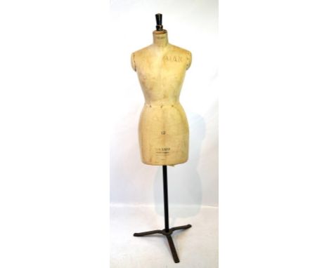 A Stockman tailors dummy, circa 1910 
The linen clad torso raised on a black painted metal stand on a tripod base, and surmou