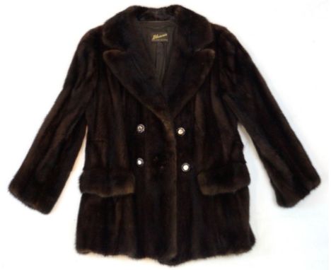 A circa 1960's chocolate brown ranch mink jacket
Of fitted form with self lined double collar to double breasted button detai