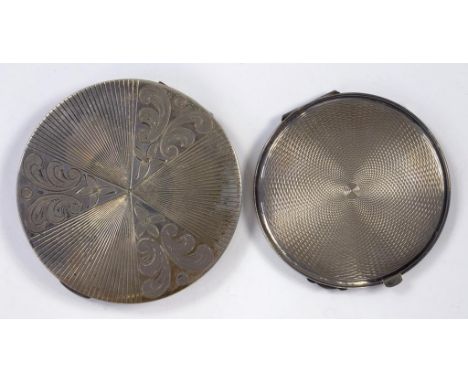 AN ENGRAVED AND ENGINE TURNED ROUND SILVER COMPACT, 8CM DIAM AND ANOTHER, SMALLER, BIRMINGHAM 1947