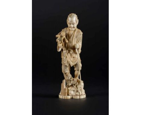  An ivory okimono depicting a man with a monkey, signed at the baseJapan, late 19th centuryCm 11,00 x 32,00 x 9,00 22.00 % bu