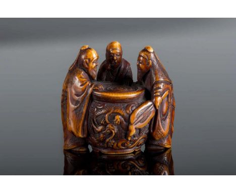  An ivory netsuke depicting three characters around a carved trunk. Signed Masa Yana at the base Japan, 19th centuryCm 3,00 2