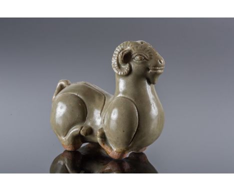  A stoneware celadon glazed kneeling ramChina, Jin dynasty, 4th century or laterCm 13,50 x 14,00 22.00 % buyer's premium on t