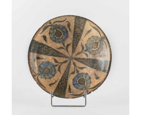  A fritware pottery bowl with cruciform panel decoration with epigraphy and flowersIran, Kashan, 13th century Restored.Cm 22,